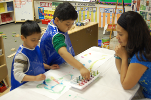 Boy uses pointer on number chart